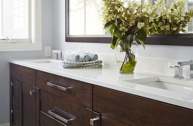 Bathroom vanity with white countertop and sinks