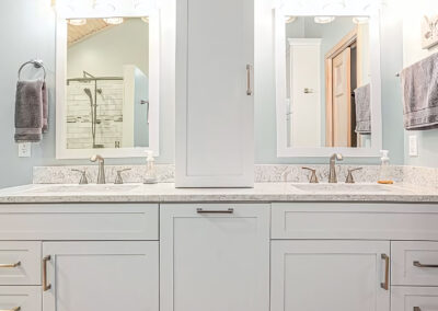 New bright Bathroom Design and Lighting with two sinks and vanities with mirrors above
