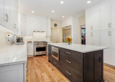 Improved Kitchen Layout and Island with white design theme throughout for brighter surfaces