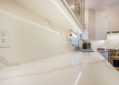 Beautiful Quartz Countertop and Backsplash adds brightness and light to the kitchen