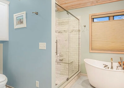 New bath shower with glass doors and nearby white tub