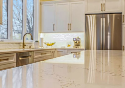 Beautiful bright new Kitchen Countertops with detail of surface visible and sink and refrigerator in background