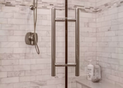 Close up view of New Bath Shower Door Handles and glass