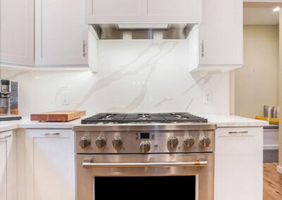 Beautiful Kitchen Cooking Area with new stainless steel oven range and improved lighting