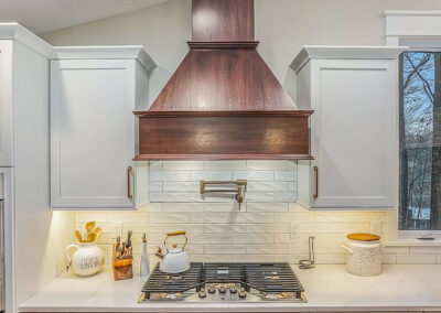 Kitchen Stove and Counters with exhaust hood visible above cooking surface