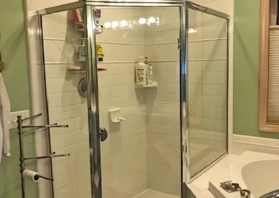 Shower before renovation, showing glass doors of old shower area