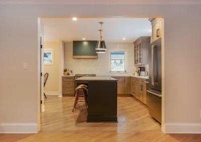Kitchen after renovation, showing large new island and entryway