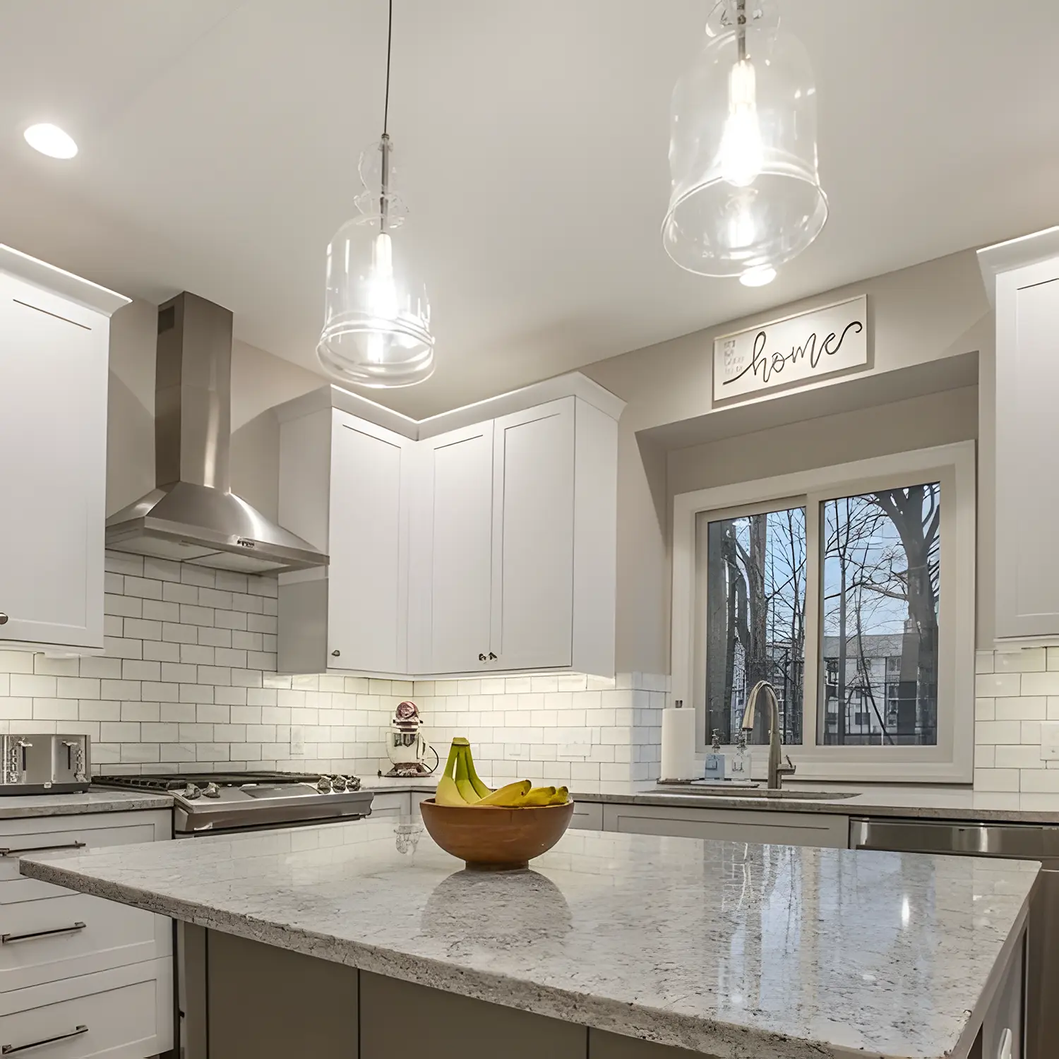 Gorgeous New Kitchen Lighting over Island with oven and kitchen sink in rear