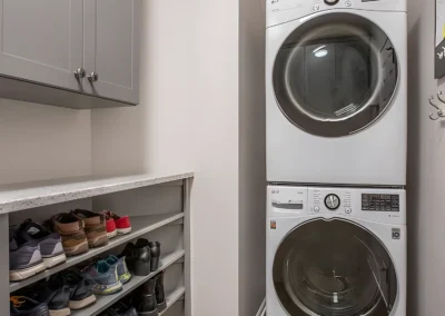 New Laundry Machines and shoe storage in utility space of new renovation